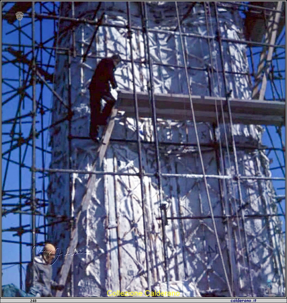 Bruno Innocenti regge la scala mentre Stefano Rivetti sale sull'impalcatura del Cristo.jpg